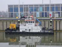 Multicat multipurpose vessel with hydraulic crane & spud pole legs
